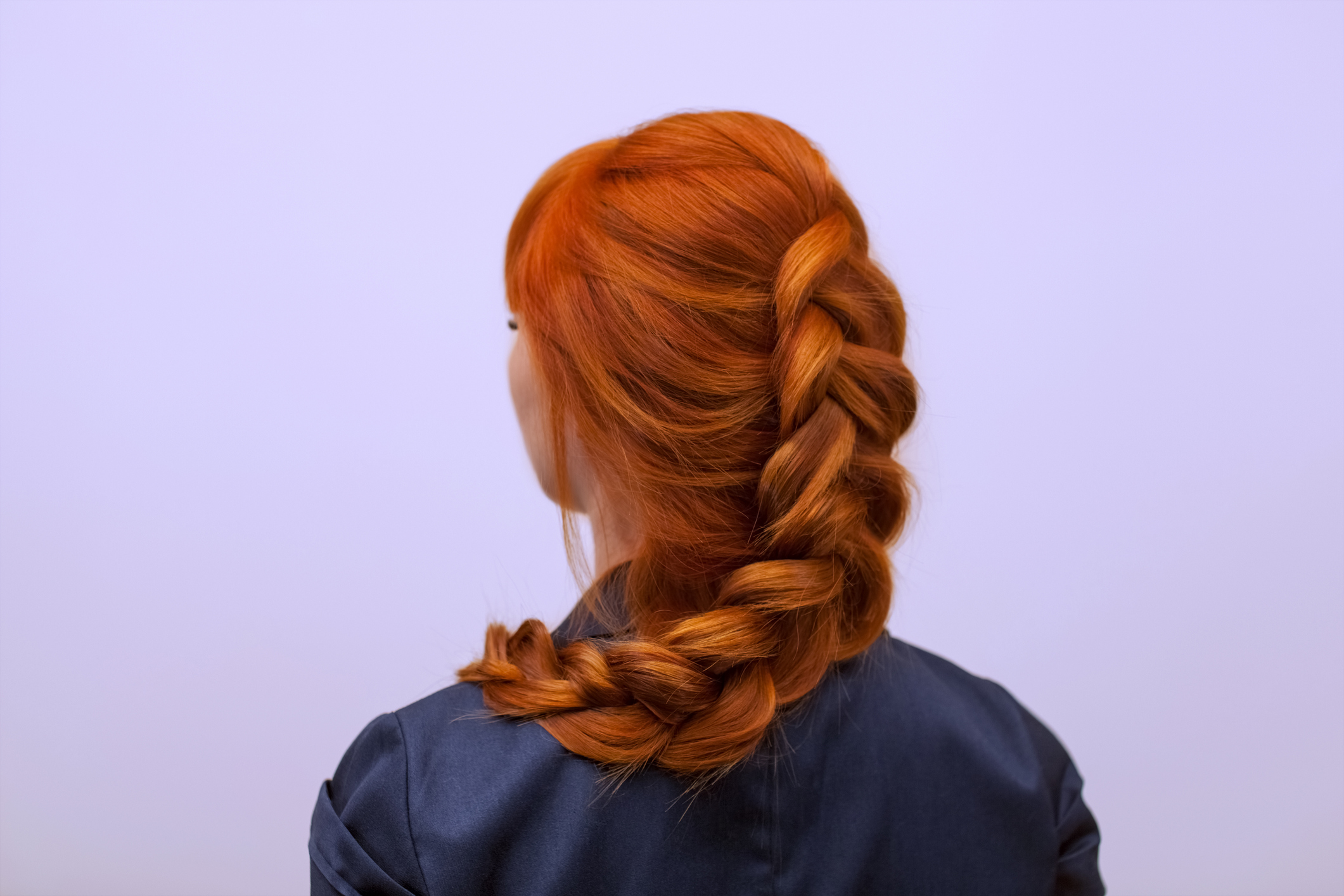 Woman with red hair in a braid with her back turned